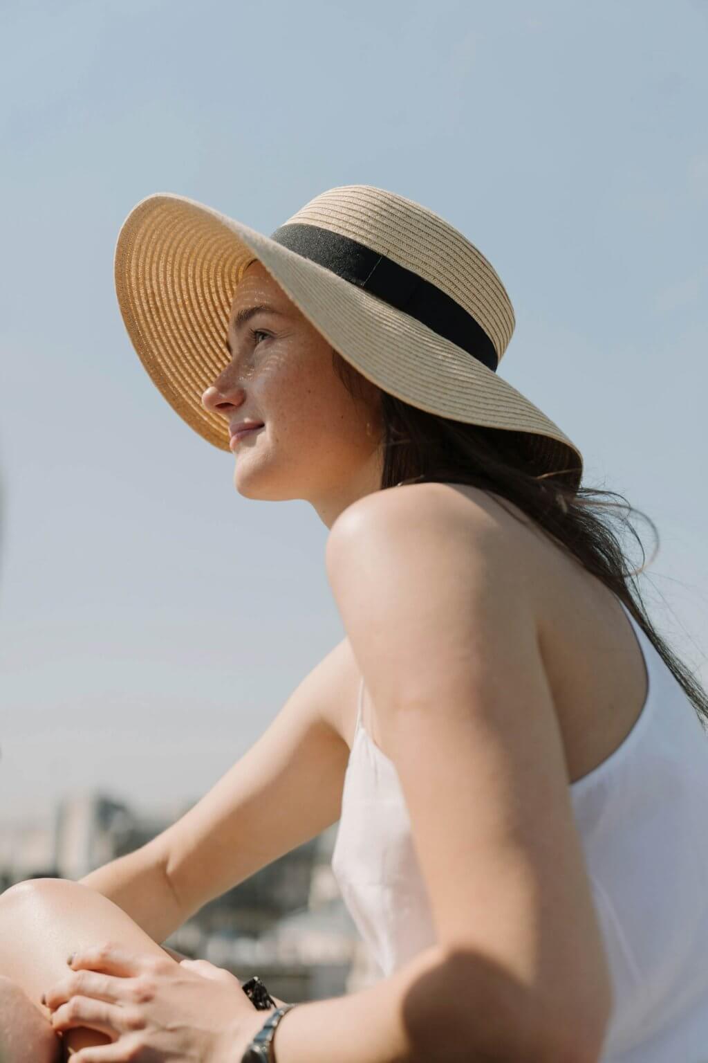a person with a sun hat on smiling at klara clermont fl apartments